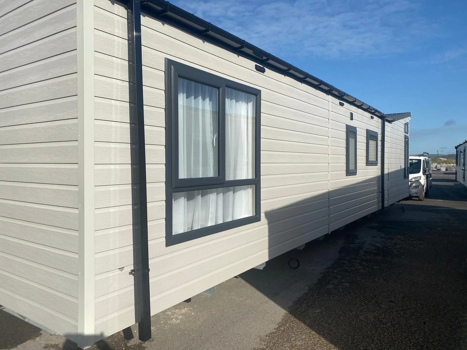 Completed static caravan exterior with replacement glazing and cream cladding